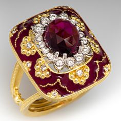 This spectacular Stambolian designer ring is centered with one (1) oval checkerboard cut natural rhodolite garnet set into an eight-prong setting. The center stone is bordered with sixteen (16) bezel set, round brilliant cut diamonds. The gallery is accented with twelve (12) flush set, round brilliant cut diamonds and bordered with purple enamel. The ring has a tapered double shank. The ring measures 22.3mm at the top, rises 14.7mm above the finger, tapering to 3.8mm wide and 1.7mm thick at the Luxury Enamel Rings For Formal Occasions, Formal Enamel Ring With Gemstone, Luxury Ruby Ring With Diamond Accents, Red Enamel Elegant Rings, Formal Luxury Enamel Ring With Gemstone, Luxury Formal Enamel Ring With Gemstone, Elegant Red Enamel Ring, Formal Oval Enamel Ring Hallmarked, Oval Enamel Ring In Fine Jewelry Style