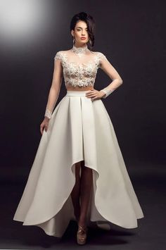 Patima- An exquisite two-piece wedding dress featuring an elegant high-neck lace crop top and a flowing high-low satin skirt, perfect for a stylish bride. Size: Don't worry about sizing at this time. After ordering, we'll send you a measurement guide and address any queries you have. If you need, we will guide you through the measuring process. Upon receiving your details, we'll review them meticulously and reach out to confirm everything. With your details confirmed, we'll begin crafting your dress, and you can concentrate on planning your wedding. For any pre- or post-order questions, please contact us. We offer customization options like neckline alterations, sleeve modifications, and combining elements from different dresses. For custom details, please get in touch before ordering. Pro Wedding Dress Trendy, Texture Wedding, Wedding Dress With Sleeves, Unique Wedding Dress, Two Piece Wedding Dress, Dress Trendy, Wedding Skirt, Embroidered Designs, Bridal Separates