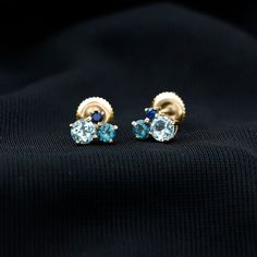 Product Details These Three Stone Stud Earrings embellished with Round Shape Sky Blue Topaz, London Blue Topaz and Blue Sapphire Gemstones are set in a Prong Setting. Product Information SKU SHP-EARRINGS102025073 Length 6 mm Width 7.2 mm Height 3.2 mm Weight 0.88 gm (Approximate) BLUE SAPPHIRE INFORMATION No.of Stones 2 Pieces Total Weight 0.10 Carat (Approximate) Dimension(approx) Round-2X2 mm-2 Pcs Color Blue Cut Brilliant Shape Round Setting Type Prong-Setting Quality Grade AAA LONDON BLUE TO Formal Blue Birthstone Earrings, Blue Birthstone Earrings For Formal Occasions, Blue Topaz Multi-stone Earrings, Light Blue Gemstone Earrings - Fine Jewelry, Blue Prong Set Fine Jewelry Earrings, Blue Cluster Earrings Fine Jewelry, Fine Jewelry Blue Cluster Earrings, Blue Cluster Earrings In Fine Jewelry Style, Yellow Gold Earrings With Blue Topaz And Gemstone Accents