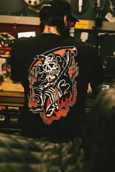 The In Flames tee takes inspiration from our iconic "Reap What You Sew Tee." Designed by Mark Storey, he put his own twist on this classic design. Black 6oz Classic Fit 100% Cotton Printed in California, USA In Icon, In Flames, Blog Instagram, Hoodies For Sale, California Usa, Apparel Design, Tee Design, Classic Design, Twist