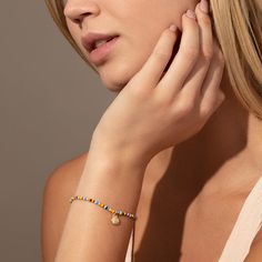 Every summer look needs our Beaded Shell Bracelet. This colorful bracelet features a gold shell charm that’s perfect for every beach trip. For a full look, pair this beaded bracelet with our Beaded Shell Necklace. Gold Beaded Bracelets For Vacation, Gold Bracelets With Round Beads For Vacation, Gold Strand Beaded Bracelets For Summer, Gold Strand Beaded Bracelets For Vacation, Gold Friendship Bracelets With Colorful Beads For The Beach, Beach Bracelets With Gold Beads, Gold Stretch Bracelet With Colorful Beads For Summer, Beachy Gold Beaded Bracelets, Gold Beaded Charm Bracelet For Beach