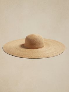 This timeless hat is woven from beautiful, natural raffia with an extra wide brim for added sun protection and a touch of drama.  Interior sweatband, Brim: 8" Crown height: 4. 5" S/M: 22. 5" circumference M/L: 23. 5" circumference Rafia Hat, Spain Outfit, Party Sale, Jurassic Park, Wide Brimmed, Artsy Fartsy, Minimal Fashion, Straw Hat, Hat Fashion