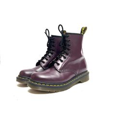 Vintage Y2K purple leather 8-eye 1460 lace up combat boots by Dr. Martens. Features dark purple leather uppers, rounded toe, 8-eye lace up fronts, combat style, above-ankle rise, flat tops, pull on loop at center back, classic yellow welt stitching, thick chunky sole, and short block heel. Excellent vintage condition.   Heel to toe (inside shoe): 9.625 inches  Ball of foot (bottom of sole): 4.125 inches  Heel height: 1.125 inches  Rise: 6.375 inches  Size 7 Purple Lace-up Boots For Streetwear, Purple Round Toe Boots For Streetwear, Casual Purple Boots For Streetwear, Purple Leather Lace-up Boots, Purple Lace-up Leather Boots, Combat Style, Inside Shoes, Lace Up Combat Boots, Milwaukee Wi