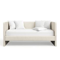 a white couch with pillows sitting on it's back end and the seat upholstered