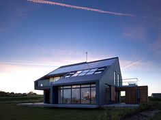 a modern house with solar panels on the roof