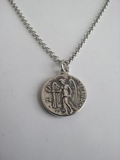 Varouxi Pendant Goddess Athena Silver 925 a very nice pendant in silver 925 a souvenir from ancient Greece accompanied by a silver chain 925 length 45cm Diameter coin:18mm Weight coin:5,0gr total weight:9,2gr Metal:silver 925 MACEDONIAN KINGS. Alexander the Great. 323-317 B.C. E. Head of Goddess Athena O.The Goddess Nike with laurel wreath All creations are specially designed, hand cast of solid silver, and individually polished Black oxidised background to enhance ( coin ) symbols Made entirely Antique Coin Pendant Necklace As Gift, Symbolic Sterling Silver Charm Necklace With Coin Pendant, Ancient Engraved Round Pendant Necklace, Ancient Style Engraved Round Pendant Necklaces, Sterling Silver Amulet Coin Necklace, Ancient Style Engraved Round Pendant Necklace, Symbolic Silver Coin Necklace, Silver Symbolic Coin Necklaces, Sterling Silver Coin Pendant Medallion Necklace