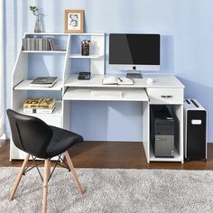 a white computer desk with a monitor and keyboard