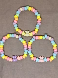 ""Kawaii" is a word that describes a style of art, design, and behavior that conveys cuteness, innocence, and joy." (Merriam-Webster). This Bunny Kandi Bracelet bracelet exemplifies what kawaii is with its adorable bunny beads and pastel rainbow colors.  This handmade bracelet is 18cm. (7in.) in length and is made with plastic and acrylic beads. The pony beads seen are the standard 5mm size, whereas the bunny and star beads are 10mm and 8mm respectively. The whole piece is tied together with a s Adjustable Cute Kawaii Jewelry, Kawaii Jewelry With Cute Adjustable Design, Adjustable Kawaii Jewelry With Cute Design, Cute Handmade Yellow Beaded Bracelets, Adjustable Multicolor Whimsical Beaded Bracelets, Whimsical Adjustable Multicolor Beaded Bracelets, Whimsical Multicolor Jewelry With Cute Design, Multicolor Beaded Kawaii Jewelry, Handmade Pastel Beaded Bracelets Playful Style