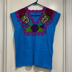 Handmade Never Worn Beautiful Colors Blue Casual Top With Floral Embroidery, Casual Blue Top With Floral Embroidery, Casual Blue Embroidered V-neck Top, Blue V-neck Top With Floral Embroidery, Spring Blue Geometric Embroidered Blouse, Light Blue Floral Embroidered V-neck Top, Blue Blouse With Geometric Embroidery For Spring, Blue Casual Embroidered V-neck Top, Light Blue Embroidered V-neck Top