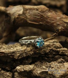 Twig engagement ring is nature inspired. Stone delicate frame is made in vintage style. Blue topaz gives the ring lightness and airiness. ■ All wedding rings are only crafted with the finest of recycled metals DETAILS: Stone - 9mm Natural Topaz, weight approx. 2.44ct. Metal - Sterling Silver Dimensions - width 9mm (0.35 in.), band width - 2mm (0.196 in.) Finish - shiny and oxidized (shiny at your request) Please choose your ring size and gems in menu while making your order View all tree bands a Unique Sterling Silver Topaz Ring For Wedding, Nature-inspired Solitaire Jewelry For Weddings, Rustic Silver Jewelry For Wedding, Rustic Hand Forged Wedding Rings, Rustic Sterling Silver Jewelry For Anniversary, Unique Hand Forged Engraved Promise Ring, Rustic Handmade Wedding Jewelry, Unique Handmade Topaz Wedding Ring, Handmade Unique Topaz Wedding Ring