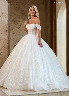 a woman in a white wedding dress posing for the camera with her hand on her hip