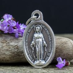 Traditional Miraculous Mary medal. This silver oxidized medal has gorgeous details and would be a lovely addition to your next rosary or jewelry project. It is imported from Italy and ready to be used in your next jewelry design. The Miraculous Medal is one of the most popular Catholic medals. It was created by St. Catherine Laboure following a vision of the Blessed Virgin Mary in 1830. This medal is believed to bring special intercessions on behalf of the Blessed Virgin Mary if worn with faith St Catherine Laboure, Catherine Laboure, The Immaculate Conception, The Blessed Virgin Mary, Immaculate Conception, Catholic Medals, St Catherine, Blessed Virgin, Blessed Virgin Mary