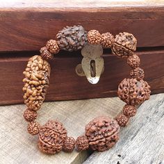 📿This unique bracelet is made from genuine sacred seeds of 2- 7 Mukhi Rudraksha. Wear this wrist seed bracelet to reap its amazing benefits.📿 2 Mukhi Rudraksha - It is also beneficial for those who are in search of the best life partner. It also helps to bring pleasure and spiritual gains to the wearer life. 3 Mukhi Rudraksha - Three Mukhi rudraksha has a soothing effect on one's mind and body. Three Mukhi Rudraksha is the form of three types of Agni (fire) and also the symbol of Three Deva i. Handmade Brown Beaded Bracelets For Ceremonial Use, Handmade Brown Beaded Bracelets For Rituals, Spiritual Brown Beaded Bracelets For Rituals, Spiritual Brown Rosary Bracelet For Meditation, Spiritual Handmade Wristband For Festivals, Handmade Spiritual Wristband For Festivals, Spiritual Brown Beaded Bracelets, Spiritual Brown Bracelet For Festivals, Spiritual Brown Bracelet For Meditation