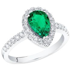 an emerald and diamond ring with white diamonds on the band, set in 18k white gold