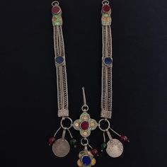 Handmade in Taroudant. This chain is worn with a fibula. Very old silver and rare. Very old glass agate. A rare masterpiece. The pendants in the middle (herz) are old dated silver coins. In good condition and fast shipping. It can be a necklace by adding a chain and a key. Who wants it as a necklace I can make it as necklace. Raw silver. *weight: 123 gram *Length and width The chain (On one side) : 18.5 cm / 1.5 cm *length all chain : 43.5 cm If there is any other question sand me a message and Middle Eastern Necklace, Moroccan Coin Necklace, Berber Traditional Clothes, Berber Earrings, Berber Jewelry Morocco, Berber Jewelry, Moroccan Jewelry, Silver Coins, Chains Necklace