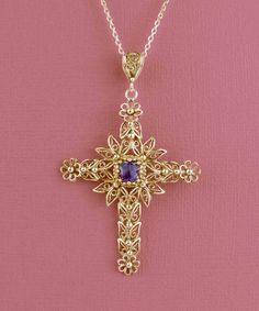 Looking for a meaningful and elegant piece of jewelry? Our handmade gold-plated solid silver filigree art cross pendant featuring a beautiful Amethyst gemstone is the perfect option. The cross is a Christian religious symbol that represents faith, good fortune, and protection. Our expert artisans have crafted the filigree art details inspired by nature, making each piece unique and special. The Amethyst gemstone is 6.00mm double-side faceted, checkerboard round-cut, adding a touch of luxury to t Yellow Gold Filigree Cross Pendant Necklace, Spiritual Crucifix Gemstone Jewelry, Ornate Cross Necklace With Intricate Design, Spiritual Cross Necklace With Intricate Design, Elegant Crucifix Jewelry For Jewelry Making, Gold Cross Gemstone Jewelry, Elegant Jewelry With Intricate Design Cross Pendant, Byzantine Gemstone Jewelry For Gift, Crucifix Necklace With Intricate Design For Gifts