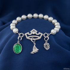 a bracelet with pearls and charms on it