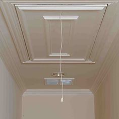 an empty room with a ceiling fan and some wires hanging from it's sides