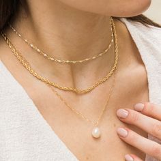 The Baroque Pearl necklace is a gorgeous addition to any look. Featuring a freshwater pearl whose shape is one of a kind (just like you!) this piece makes a sweet statement. It's perfect for all your outings, whether it's to get your morning matcha or to join your friends for a girls' night in town. Feel adorable and stylish wearing it on any occasion! DETAILS Necklace length: 18" with 2" extender 14k gold filled -or- sterling silver chain, spring clasp, & findings 10-12mm baroque freshwater pea Classic Pearl Necklace, Pearl Chain Necklace, Detailed Necklace, Bracelet Pearl, Baroque Pearl Necklace, Summer Necklace, Pearl Hoop Earrings, Necklace Simple, Matching Bracelet