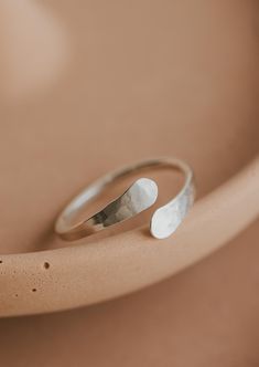 An updated version of our cuff ring. This time we made the ends pass by one another. Inspired by the definition of sonder: the realization that each random passerby is living a life as vivid and complex as your own. 14g wire is hand-shaped and hammered for texture. Available in 14kt Gold Fill + Sterling Silver. Shown with our Confetti Rings and Raye Ring. Handmade in Eau Claire, WI All of our jewelry is handmade to order so each piece will be unique and may vary slightly from what is pictured. Confetti Rings, Poppy Ring, Everyday Wear Jewelry, Cuff Ring, Cuff Rings, Circle Studs, Small Rings, Beaded Rings, Lariat Necklace