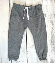 These durable everyday sweats are our new favorite everyday must have! Custom made in 100% soft ,medium weight -french terry. These comfortable bottoms have a elastic waist with a cotton drawstring. The drawstring can also be easily removed if desired. Finished with handy side pockets to store whatever your little one wants to grab & go with. Will shrink up to half size in a hot drier. These run true to size. Offered in even size only. Casual Cotton Sweats For Playwear, Spring Cotton Joggers With Ribbed Waistband, Gray Sweats With Elastic Waistband For Jogging, Comfortable Gray Sweats With Elastic Waistband, Casual Fleece Joggers For Lounging, Basic Cotton Sweats For Lounging, Basic Spring Joggers With Elastic Waistband, Spring Cotton Stretch Sweats, Comfy Cotton Joggers With Drawstring