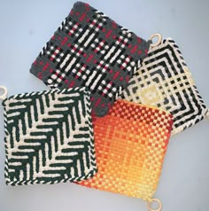 three woven bags with different patterns on them, one is orange and the other is black