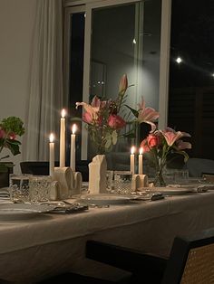 the table is set with candles and flowers