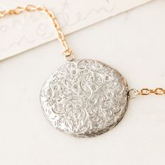 This one-of-a-kind necklace is composed of: Victorian, sterling silver dress pin from the late 1800s with hand-engraved scrollwork and ivy design details on the front. This piece was originally made sourced in England. This necklace measures a standard 18” on a modern 14k gold filled chain. The pendant measures 1" in width. Dress Pin, Charm Rings, Silver Dress, Signature Jewelry, Victorian Jewelry, Gold Filled Chain, Antique Rings, Hand Engraving, Bracelets And Charms