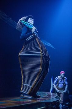 a man standing on top of a wooden structure in the middle of a dark room