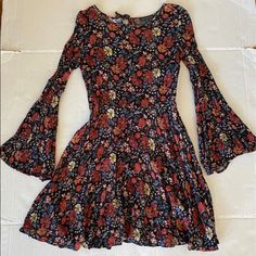 Women Size Xxs American Eagle Plum Thread Flowered Long Bell Sleeved, Round Neck, Shorter Length Fall Dress With Small Zipper On Side And Tie At Back Of Neck. New Without Tags. Red Fitted Printed Floral Dress, Red Printed Fitted Floral Dress, Fitted Red Printed Floral Dress, Fitted Red Floral Printed Dress, Bohemian Fitted Floral Print Mini Dress, Casual Fall Floral Print Dress, Casual Floral Print Dress For Fall, Casual Multicolor Bell Sleeve Dress, Spring Casual Bell Sleeve Dresses