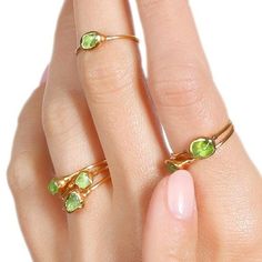 "A minimal peridot  ring with a petite 14k gold filled shank. These  tumbled peridots are genuine and natural, and complemented with a textured setting on either end. This ring stacks well with other raw crystal rings. This ring has been dipped in genuine 24k gold. A lovely gift for August babies as peridot is the birthstone for August.  ✨ 14k Gold Filled Shank 24k Gold Dipped for deeper color Genuine Peridot, 3.5-5mm ✨ Please read our FAQ for more information on our unique materials and process Stackable Yellow Gold Peridot Jewelry, Green Crystal Birthstone Ring In 14k Gold, Green Birthstone Crystal Ring In 14k Gold, Dainty Peridot Ring For Gift, Dainty Peridot Ring Gift, 14k Gold Green Crystal Ring With Ethical Gemstones, Green Crystal Ring For May Birthstone, Green Minimalist Stackable Open Rings, Green Minimalist Open Stackable Rings