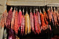 several different types of food hanging from hooks