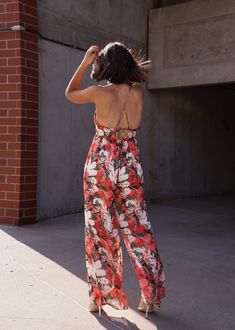 Make a chic statement with our Blossoms Abound Jumpsuit! Featuring a deep v neckline and a delicate floral print, this jumpsuit is perfect for a fun, flirty look. The cross back adds a touch of playful charm to this trendy piece. Perfect for any occasion, from brunch to date night. Fabric 100% polyester Summer V-neck Jumpsuit With Tie Back, V-neck Jumpsuits And Rompers With Smocked Back For Vacation, Floral Print Jumpsuits And Rompers For Garden Party, Summer V-neck Tie Back Jumpsuit, Summer V-neck Tie Back Jumpsuits And Rompers, Summer V-neck Tie-back Jumpsuits And Rompers, Summer V-neck Tie-back Jumpsuit, Bohemian Jumpsuits And Rompers With Smocked Back For Spring, Summer V-neck Jumpsuits And Rompers With Tie Back