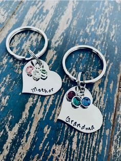 two heart shaped key chains with names on them