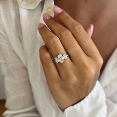 a woman's hand with a diamond ring on it