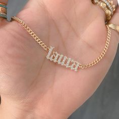 This unique personalized Old English font nameplate cut-out necklace is composed of 14K solid gold and beautifully pavé set with genuine GVs1 quality natural real Diamonds. This pendant is complemented by a durable 14K solid gold adjustable chain or can be purchased as a charm alone without the chain under the "Length" drop-down menu. NOTE: The item will be made in the exact casing of the characters entered. Please be mindful of this detail when providing the customization desired. Name Dimensio Luxury Classic Nameplate Necklace, Luxury Custom Nameplate Jewelry, Luxury Nameplate Jewelry, Wedding Nameplate Jewelry With Adjustable Chain, White Engraved Nameplate Jewelry, White Diamond Nameplate Jewelry, White 14k Gold Nameplate Jewelry, Luxury Gold Name Necklace With Custom Name, Gold Plated Custom Name Jewelry Nameplate