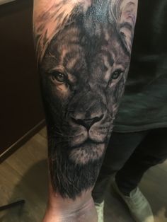 a man with a lion tattoo on his arm