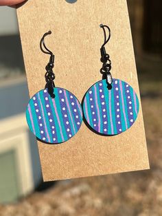 Bold patterned earrings. These are sure to make a statement, but just a little more subtle since they're smaller than our larger earrings. Purple and teal stripes with white dots, with a similar but different pattern on the back.  1 inch round, 1 inch drop Hand drawn and painted, each earring is slightly unique and made with care. Made from lightweight wood for all day comfort! Manufacturer claims on earring hooks are that they are stainless steel and hypoallergenic. All earrings are sprayed with a sealer to help protect the art. Hand Painted Artsy Earrings For Everyday, Artsy Hand Painted Earrings For Everyday, Artsy Hand Painted Everyday Earrings, Everyday Multicolor Circular Earrings, Everyday Hand Painted Artsy Earrings, Everyday Multicolor Circle Earrings, Patterns African, Polymer Cane, Hand Painted Earrings