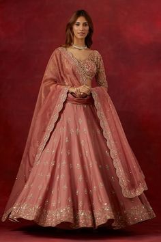 a woman in a pink lehenga