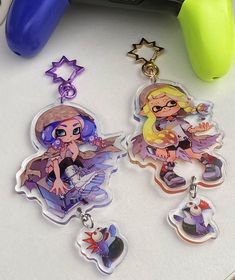 two cartoon key chains sitting on top of a table