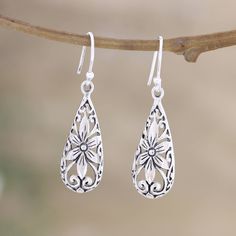 India's Ajay Patil brings us a tender design inspired by flowers and nature. These sterling silver dangle earrings feature little floral details enclosed in stylish teardrop formations. Hypoallergenic Sterling Silver Teardrop Flower Earrings, Hypoallergenic Teardrop Flower Earrings In Sterling Silver, Sterling Silver Teardrop Pierced Flower Earrings, Hypoallergenic Silver Teardrop Flower Earrings, Silver Teardrop Flower Earrings In Sterling Silver, Nickel-free Sterling Silver Teardrop Flower Earrings, Spring Sterling Silver Dangle Jewelry, Sterling Silver Dangle Jewelry For Spring, Spring Teardrop Earrings