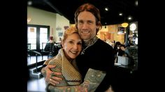 a man and woman hugging each other in a restaurant