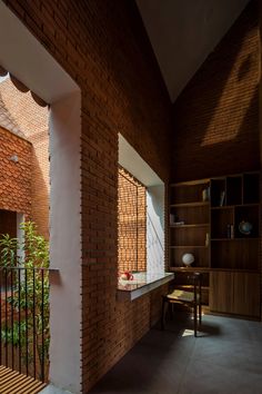 the interior of a house with brick walls and wooden shelves on either side of it