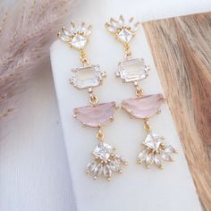 Wear this exquisite pink statement earrings to your wedding or any formal event and channel the glamorous art deco era. This art deco feature a unique arrangement of clear and light pink crystals that catch and reflect light from every angle, creating a mesmerizing play of shimmer and sparkle.The secure push back closure ensures that you can dance and mingle with confidence, knowing that your earrings will remain in place.✨Suggested occasion for wear: your wedding, wedding guest, bridal shower, Pink Glamorous Wedding Jewelry, Pink Crystal Jewelry For Evening, Glamorous Pink Wedding Jewelry, Feminine Crystal Drop Earrings For Wedding, Pink Dangle Crystal Earrings For Evening, Glamorous Gold Jewelry For Prom, Pink Sparkling Jewelry For Wedding, Feminine Crystal Jewelry For Parties, Elegant Pink Chandelier Earrings For Formal Events