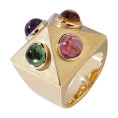 This "Pyramid Ring" made of yellow gold with one each amethyst, citrine, tourmaline and garnet cabochons impresses with its exceptional design by Wagner Preziosen. Wear it and show off! Ring Size as ordered. Shipping: 8 weeks from order date. Luxury Silver Amethyst Ring Modern Style, Yellow Gold Multi-stone Cabochons For Fine Jewelry, Yellow Gold Multi-stone Cabochons Fine Jewelry, Modern Gold Multi-stone Gemstones, Multi-stone Tourmaline Gemstones, Yellow Gold Multi-stone Cabochons For Gift, New Money Fashion, Garnet Gold Ring, Jewlery Rings