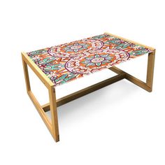 a table with an intricately designed design on the top and bottom, sitting in front of a white background