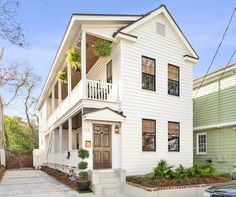 a two story house with white siding and brown trim