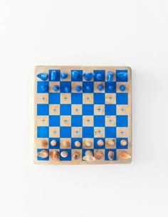 a blue and white checker board on a white surface with several pieces in it