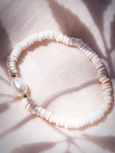 Choose one or all. These stretchy natural white puka shell bracelets evoke visions of Hawaii's white sands and soothing shores. Super rare tiny puka shells make these bracelets one of a kind.Stack these gold seashell bracelets high and you'll be ready for your tropical escape.✦ CHOICES DETAILED BELOW ✦✧ Style A: Natural White Baroque Freshwater Pearl✧ Style B: Natural Mauve Pink Freshwater Pearl✧ Style C: Natural 8-10mm Baroque Tahitian Pearl✧ Style D: Gold Filled Beads ✧ Style E: Gold Plated Sh White Strand Bracelets For Vacation, White Strand Bracelet For Vacation, Elegant Beige Beach Bracelet, Adjustable White Stretch Bracelet With Beachy Style, White Adjustable Stretch Bracelet With Beachy Style, White Strand Bracelets For Beach Season, White Bracelets For Beach Season, White Beach Bracelets For Beach Season, Handmade White Shell-shaped Bracelets