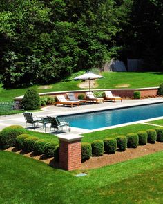 an outdoor swimming pool surrounded by lawn furniture